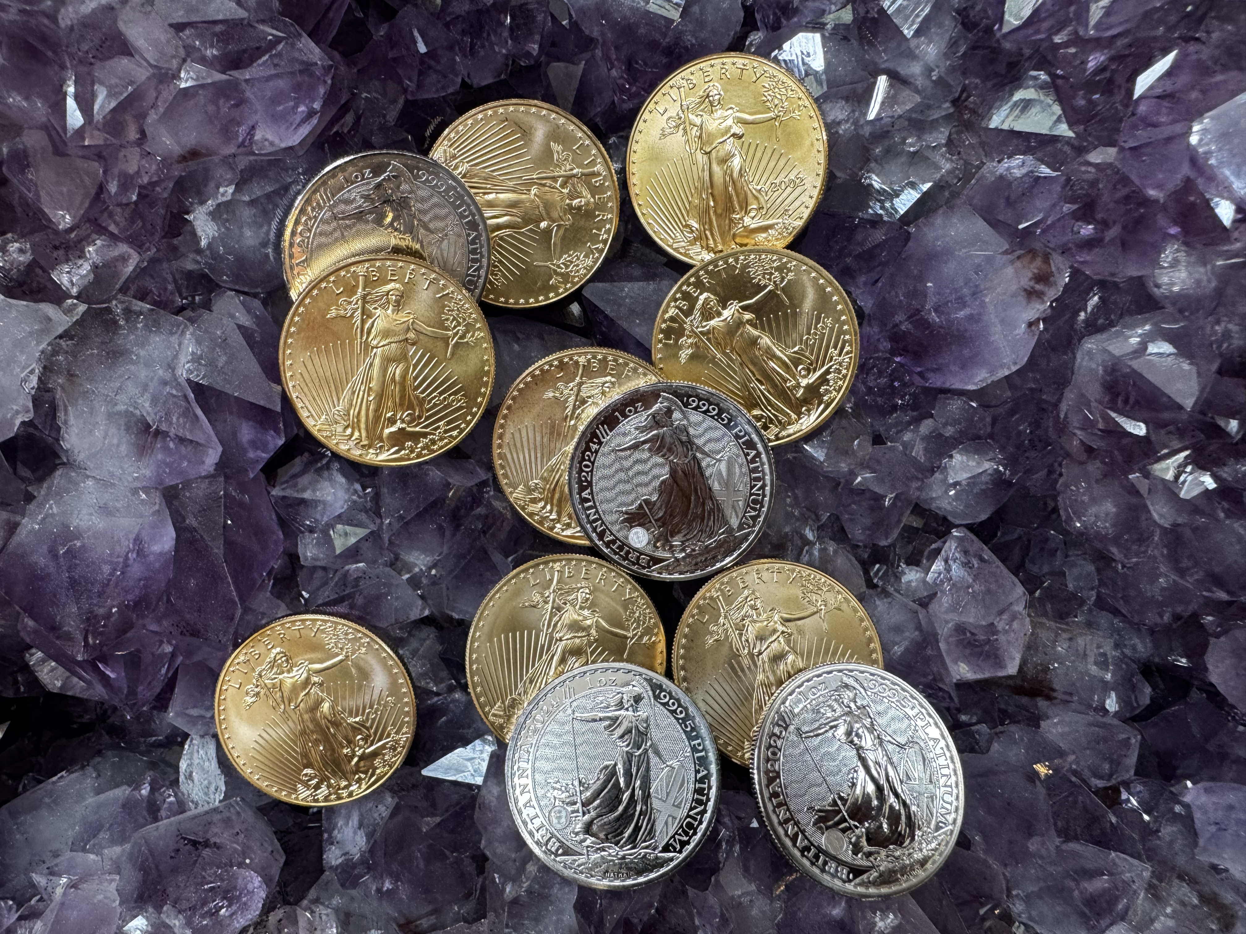 Gold and silver coins on amethyst